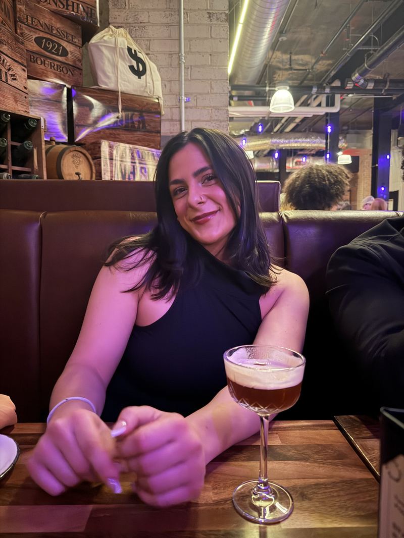 Julia smiling in a restaurant booth